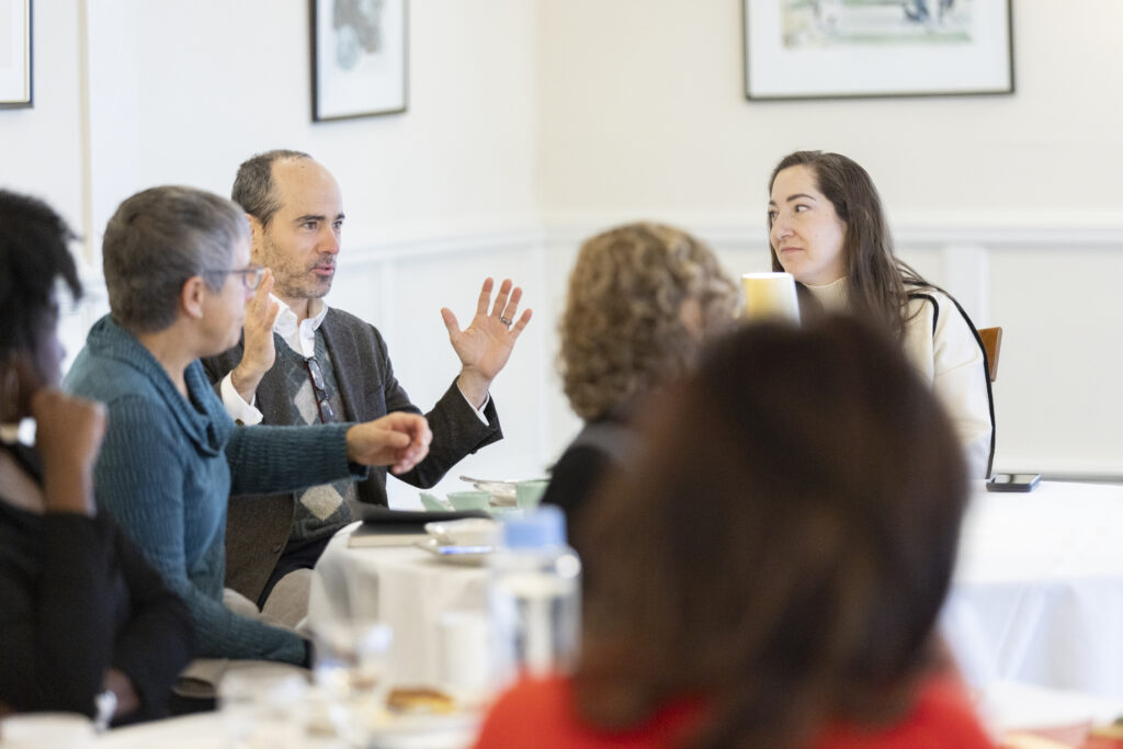 Group of Burke Fellows and Daniel P. in the middle talking with his hands.