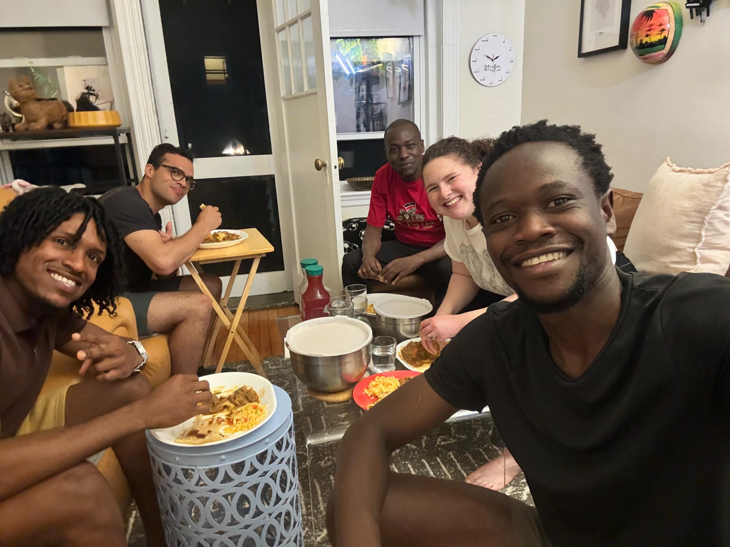 Dr. Ondigo sharing a Kenyan meal with friends from Kenya, Trinidad and Tobago, and the United States during his time in Boston.