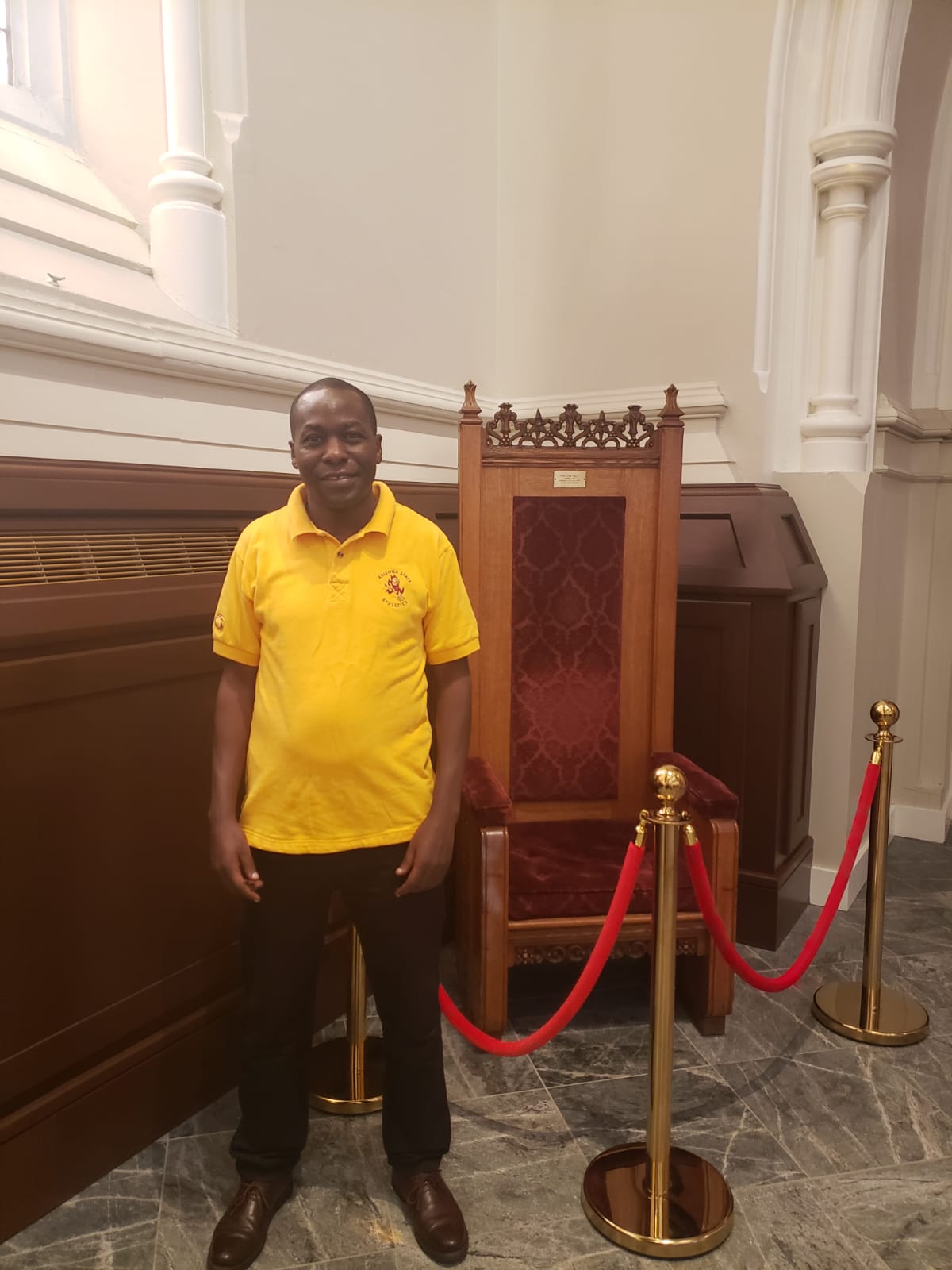A photo of myself at the Cathedral of the Holy Cross in Boston, next to me is the seat that Pope John Paul II sat on in October 1 1979, during his historic pastoral trip in the US.