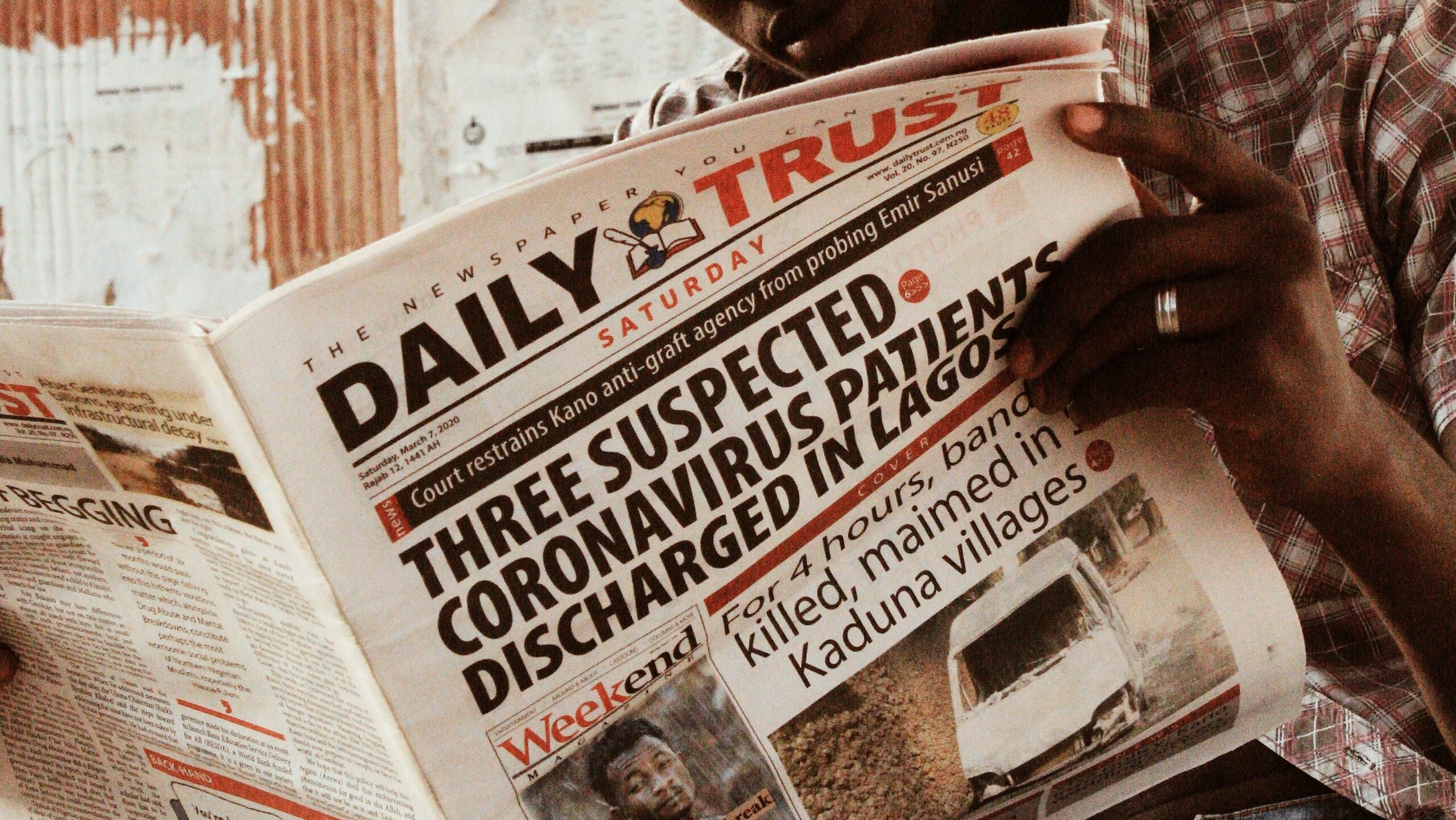 Man reading the newspaper about coronavirus patients.